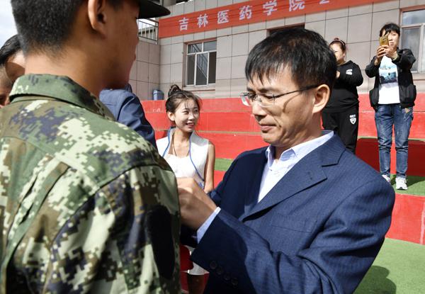 纪委书记白雪为入伍学生佩戴光荣花___.jpg